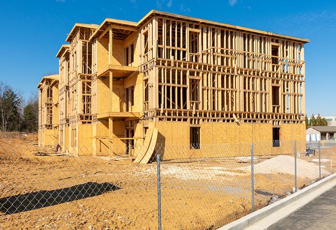 a close-up of temporary chain link fences enclosing a job site, signaling progress in the project's development in Copiague, NY